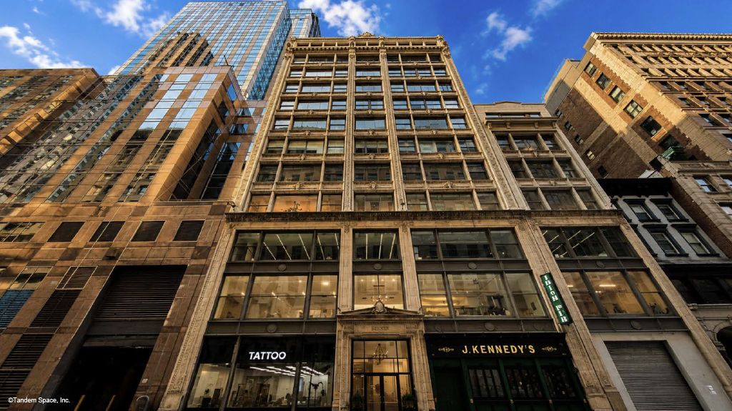 Bright Midtown Office with Exposed Brick and Glass Rooms