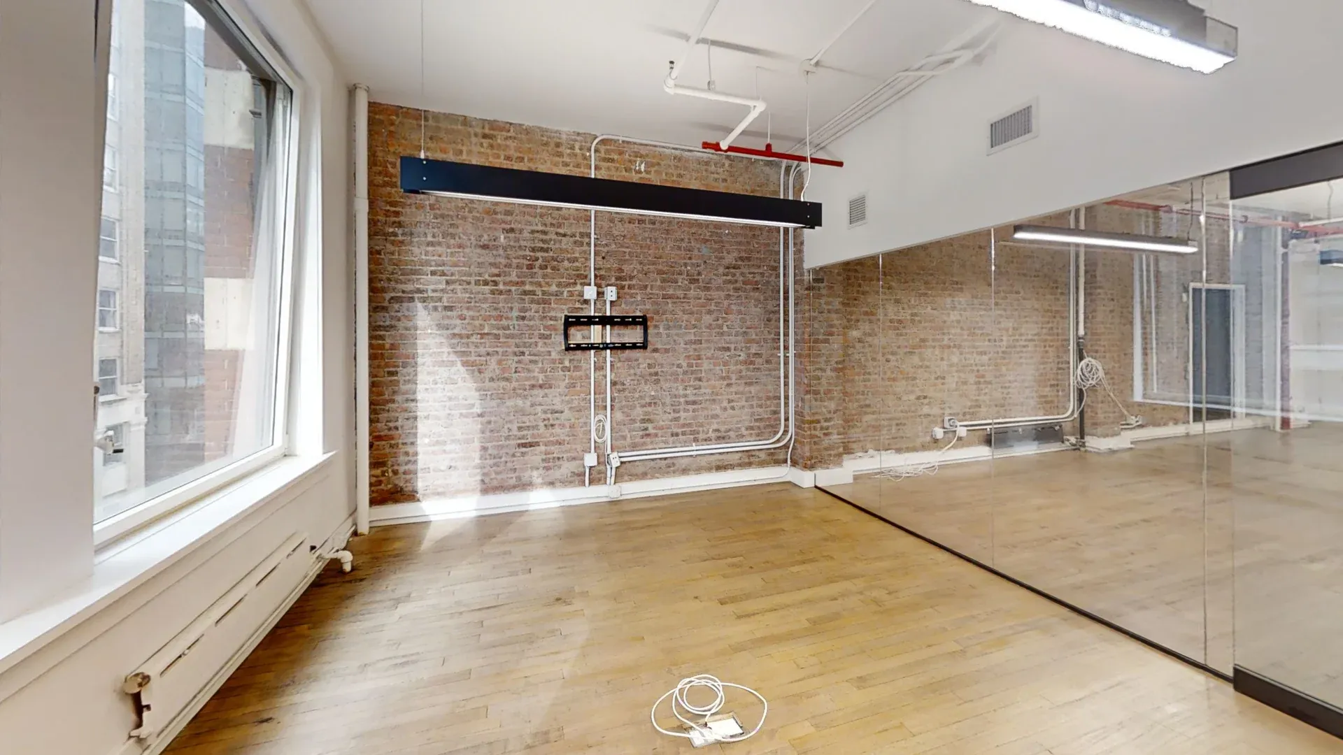 Airy Midtown Office with Exposed Brick and High Ceilings